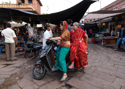 Indian women riding a scooter in the old town, Rajasthan, Jodhpur, India