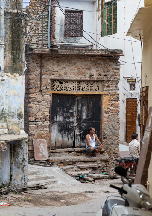 Indian man sit in front of an old door, Rajasthan, Bundi, India