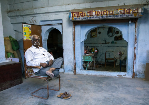 Indian man sit in front of his old house, Rajasthan, Jodhpur, India