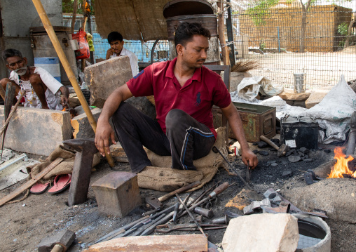 Indian blacksmith forging metal at work, Rajasthan, Jaisalmer, India