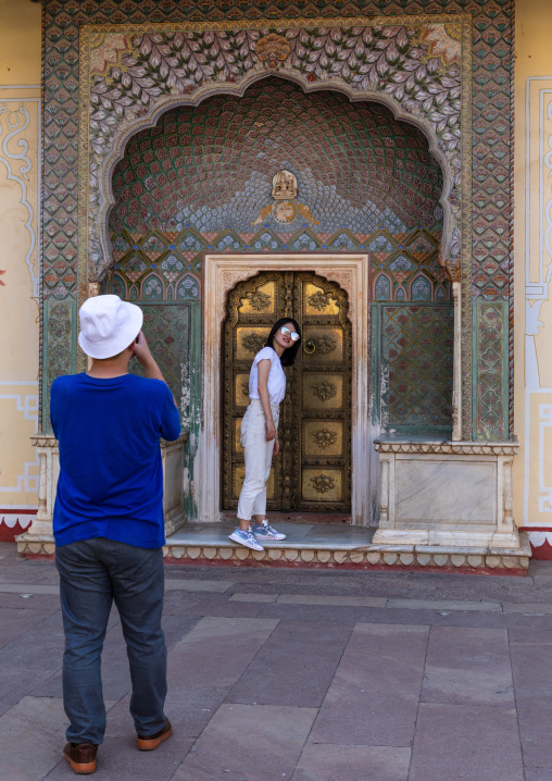 Tourists taking souvenir pictures in the chandra mahal in the city palace complex, Rajasthan, Jaipur, India