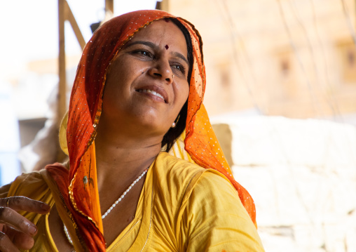 Portrait of rajasthani woman in yellow sari, Rajasthan, Jaisalmer, India