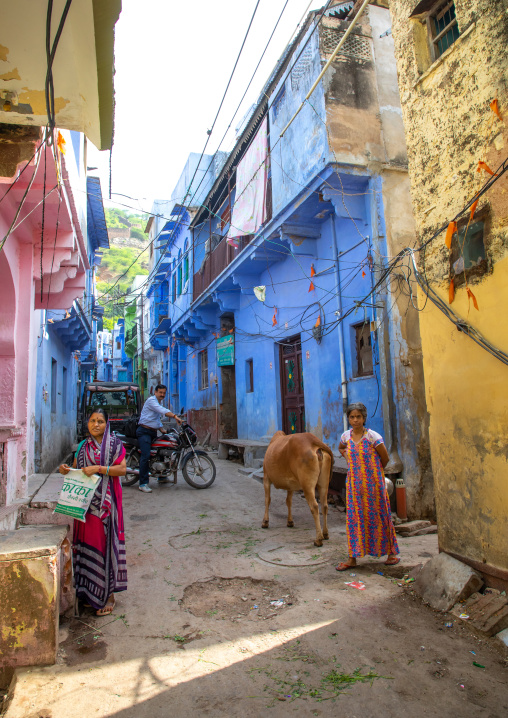Indian people in front of old blue house of a brahmin, Rajasthan, Bundi, India