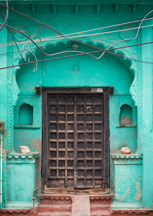 Wooden door of a green haveli, Rajasthan, Bundi, India