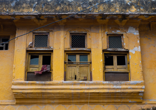 Windows of an old yellow house, Rajasthan, Bundi, India