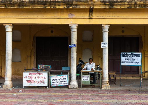 Indian man working outside a building, Rajasthan, Jaipur, India