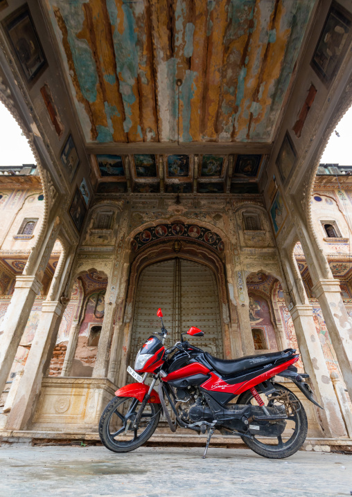 Motorbike parked in front of an old haveli, Rajasthan, Nawalgarh, India