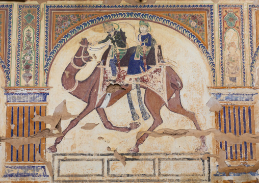 Wall paintings depicting indian people riding a camel on an old haveli, Rajasthan, Nawalgarh, India