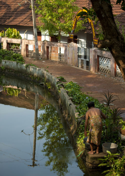 Man Alongside A Waterway On Backwaters Of Kerala, Alleppey, India