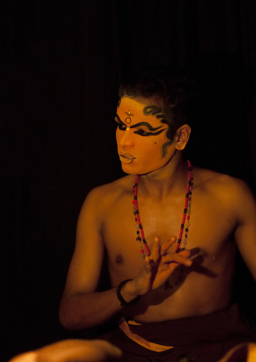 Kathakali Dancer With Traditional Face Make Up Preparing Himself For The Show, Kochi, India