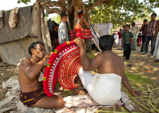 Men Preparing The Mask For Theyyam Artist Before The Ceremony, Thalassery, India