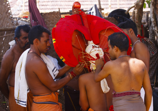 Men Putting Traditional Mask On Theyyam Artist, Thalassery, India