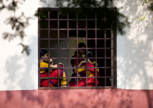 Group Of Young Women Chatting Sitting On The Edge Of A Bar Window At Dakshinachitra Dance Center, Chennai, India