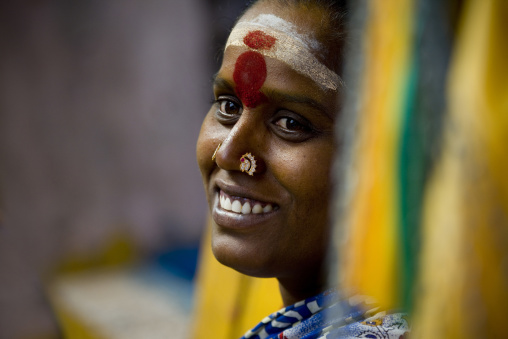Smiling Woman With Two Nose Piercings And  Traditonnal Paintings On Her Forehead In A Temple, Pondicherry, South India
