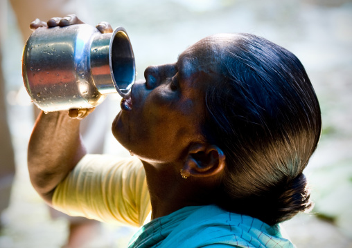 Woman Drinking Water Flowing From A Jug, Pondicherry, India