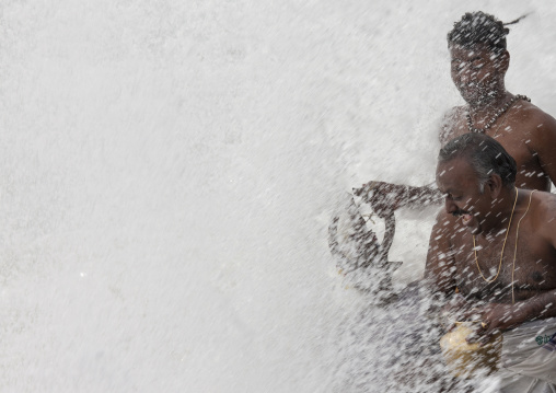 Priest And Devotees Bathing Shiva's Statue During Masi Magam Festival In Pondicherry, India