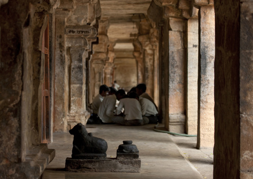 Group Of Men Sitting In Circle In The Middle Of A Cut In Rock Corridor In The Brihadishwara Temple, Thanjavur,india