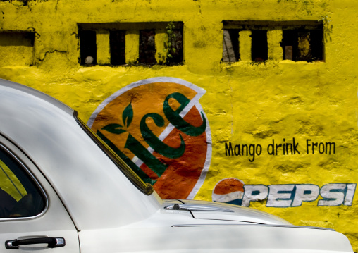 White Ambassador Car In Front Of A Painted Wall With Pepsi Advertising On It, Tirumayam, India