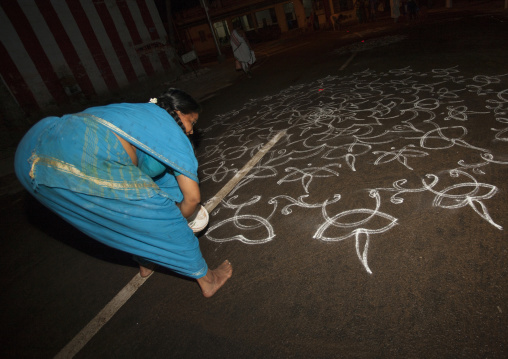 Woman In Sari Bent Down Drawing Kolam For A Ceremony In The Street, Trichy, India