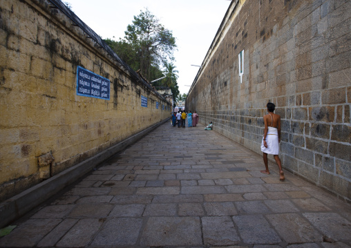 People Walking Down A Path Surrounded By Walls With Vaishnava Tilak Painted On At The Sri Ranganathaswamy Temple, Trichy, India