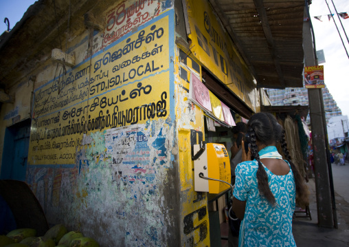 Young Woman Rear View Calling From A Public Phone In Trichy Street Next To The Sri Ranganathaswamy Temple, Trichy, India
