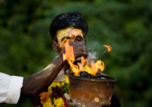 Hand Over A Jar On Fire Held By An Other Man With Closed Eyes And Traditional Painting On His Forehead During Fire Walking Ritual, Madurai, South India