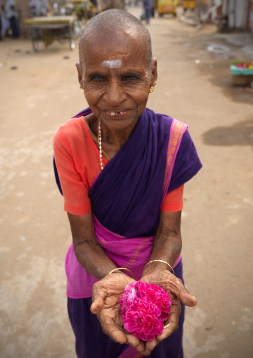 Old Flowers Seller Holding A Rose In Her Hands Next To A Temple, Kumbakonam, India