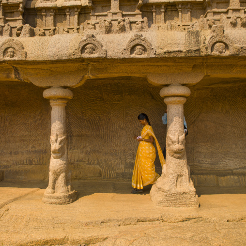 Passers-by Walking Through The Carved Hall Of The Rock Cut Bhima Ratha Temple, Mahabalipuram, India