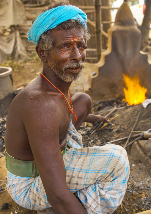 Blacksmith Holding His Tools Near A Flame In Pondicherry, India