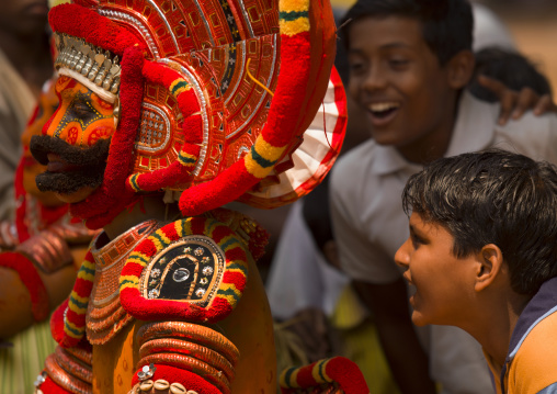 Young Smiling Boys Surrounding Theyyam Artists During The Ritual, Thalassery, India