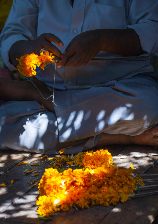 Cross-legged Man Attaching Flowers On A Thin Woodenstick At Flower Market, Pondicherry, India
