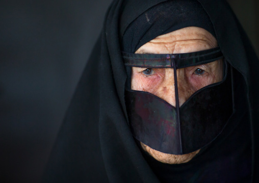 an old bandari woman wearing a traditional mask called the burqa, Qeshm Island, Salakh, Iran