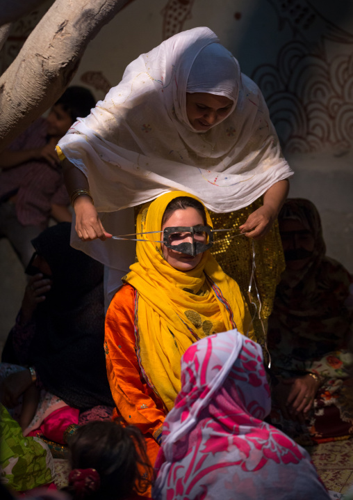 a bandari woman wearing a traditional mask called the burqa during an artistic performance in zinat house, Qeshm Island, Salakh, Iran