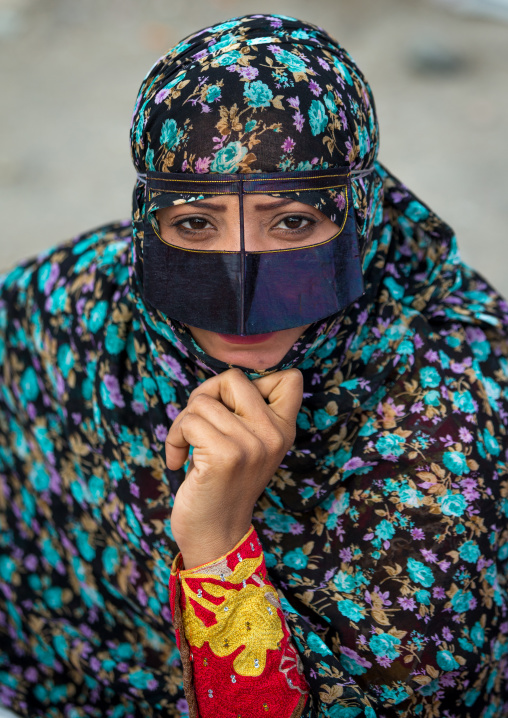 a bandari woman wearing a traditional mask called the burqa at panjshambe bazar thursday market, Hormozgan, Minab, Iran
