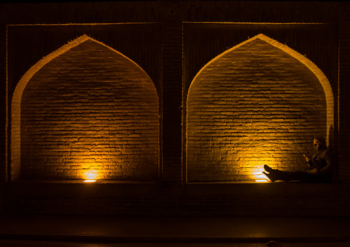 man resting under an arch at si-o-seh bridge, Isfahan Province, isfahan, Iran
