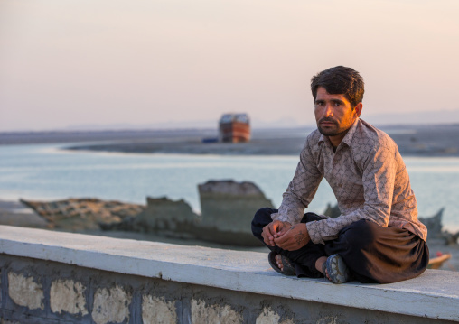 a man sitting by the sea, Qeshm Island, Laft, Iran
