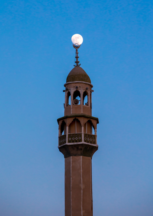 minaret of a mosque at dusk with the full moon, Qeshm Island, Salakh, Iran