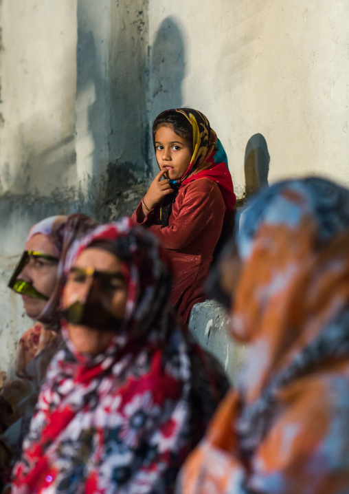 young girl in front of bandari woman wearing traditional masks called burqas, Qeshm Island, Salakh, Iran