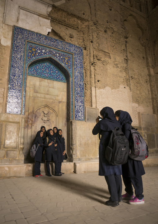 Iranian women pausing for pictures inside the friday mosque, Isfahan province, Isfahan, Iran
