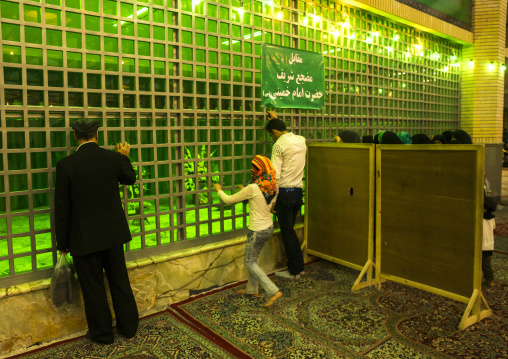 Pilgrims praying in front of the tomb of ayatollah ruhollah musawi khomeini buried next to his son ahmed khomeini, Shemiranat county, Behesht-e zahra, Iran