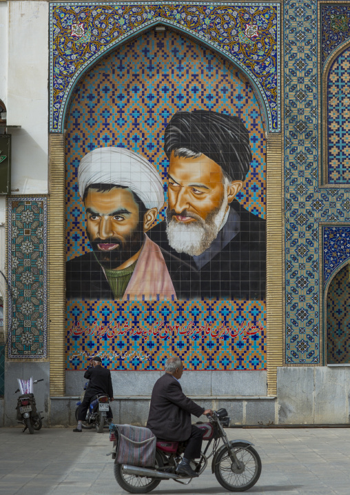 Man passing on a motorbike in front of a religious mosaic, Isfahan province, Isfahan, Iran