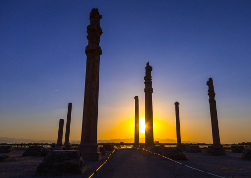 General overview of the remains of  ruins of the apadana in Persepolis at sunset, Fars Province, Marvdasht, Iran