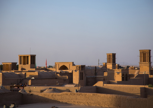 View of the city with traditional wind catchers and mosques at dusk, Yazd Province, Yazd, Iran