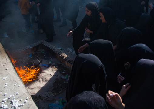 Iranian women light candles and put sugar cubes during Chehel Manbar festival on Tasua to commemorate the martyrdom anniversary of Hussein, Lorestan Province, Khorramabad, Iran