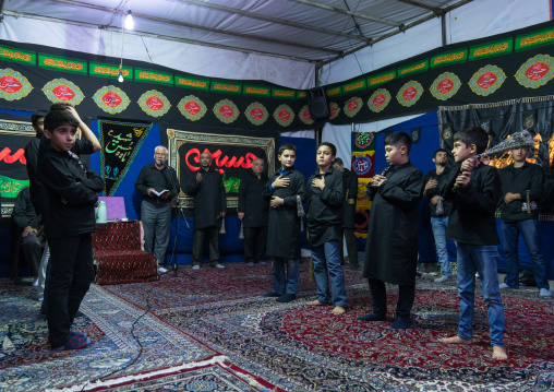 Iranian shiite muslim men beating themselves with iron chains to commemorate Ashura, Central County, Theran, Iran