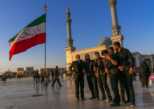 Alam carriers posing in front of Imam Hassan mosque during Muharram, Central County, Qom, Iran