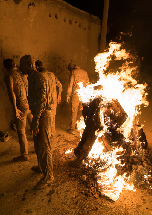 Iranian shiite muslim men gather around a bonfire after rubbing mud on their bodies during the Kharrah Mali ritual to mark the Ashura ceremony, Lorestan Province, Khorramabad, Iran