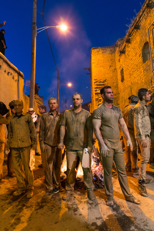 Iranian shiite muslim men gather around a bonfire after rubbing mud on their bodies during the Kharrah Mali ritual to mark the Ashura ceremony, Lorestan Province, Khorramabad, Iran