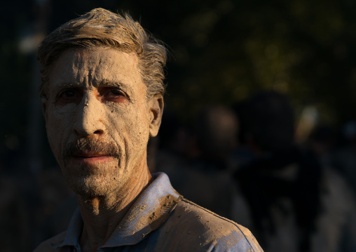 Iranian shiite muslim man after rubbing mud on his body during the Kharrah Mali ritual to mark the Ashura ceremony, Lorestan Province, Khorramabad, Iran
