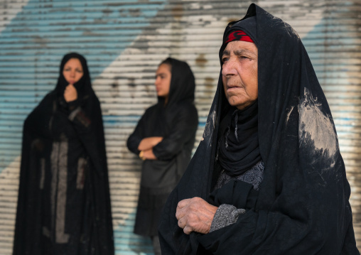 Iranian shiite muslim women with mud stains on their chadors during the Ashura ceremony, Lorestan Province, Khorramabad, Iran